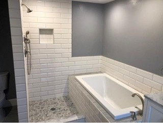 Installed custom walk in shower with drop in soaking tub adding open beauty and comfort bathing. Moreover, we incorporated large subway tiles with marble and stone rendering a modern/contemporary finish.