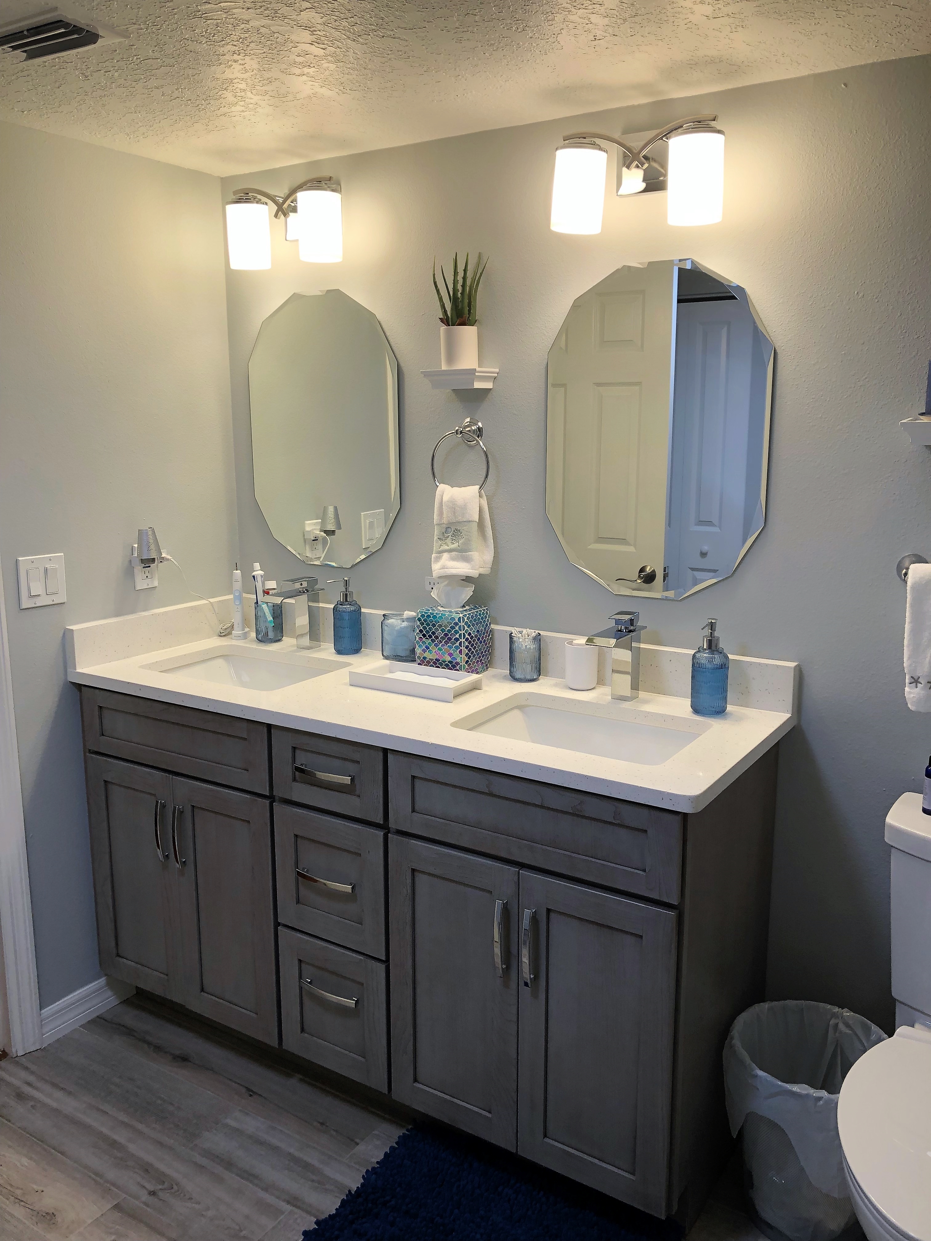 Timeless double vanity featuring matching mirrors and White Cloud quartz countertop with 4" backsplash.