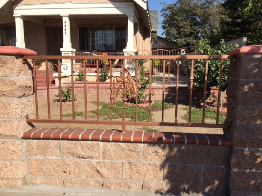 Copper collared decorative fence topping and linking stonework.