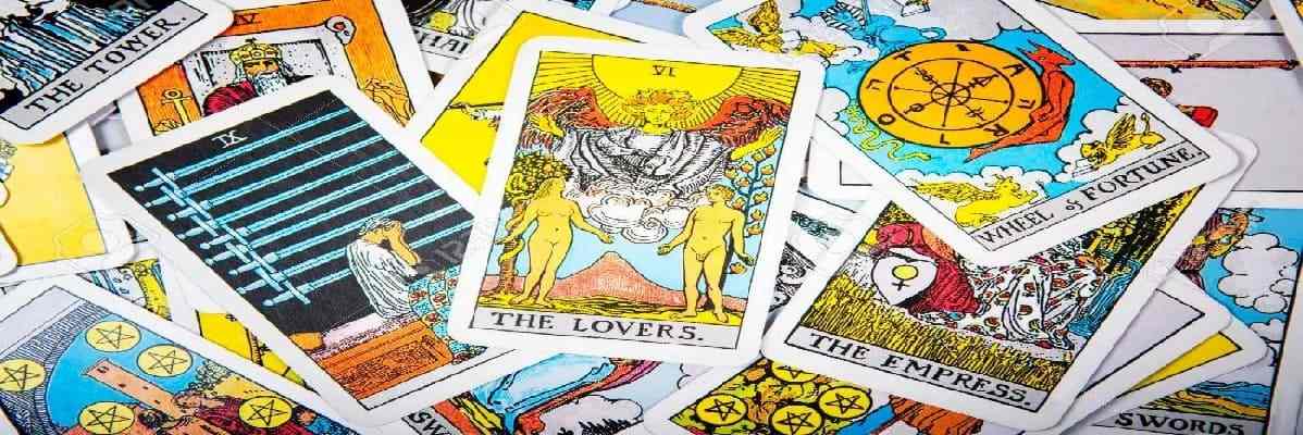 Tarot cards such as the Tower, Lovers, Wheel of fortune, and the Empress are randomly stacked atop each other, Professional Tarot card readings.