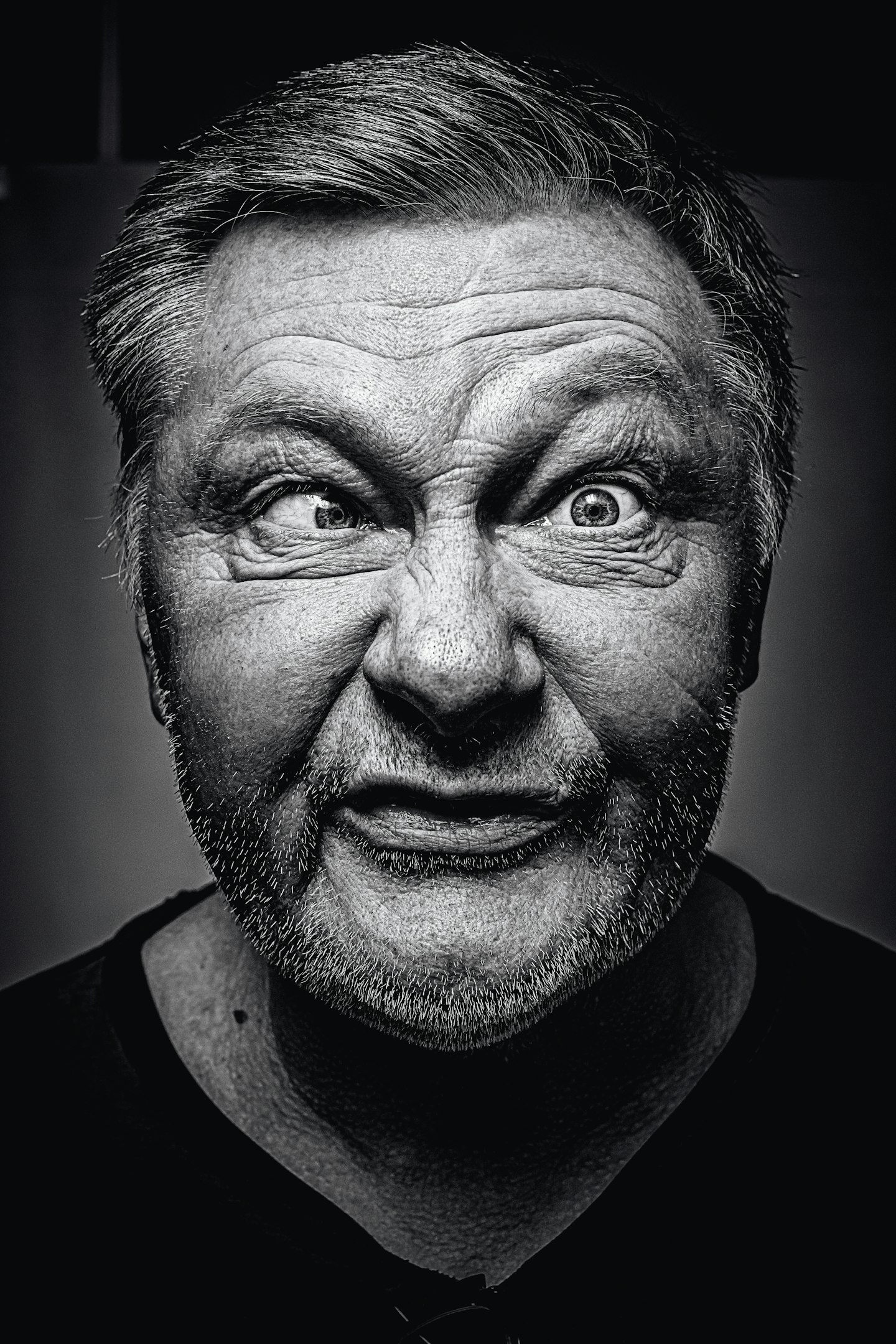 grayscale photography of man making silly face