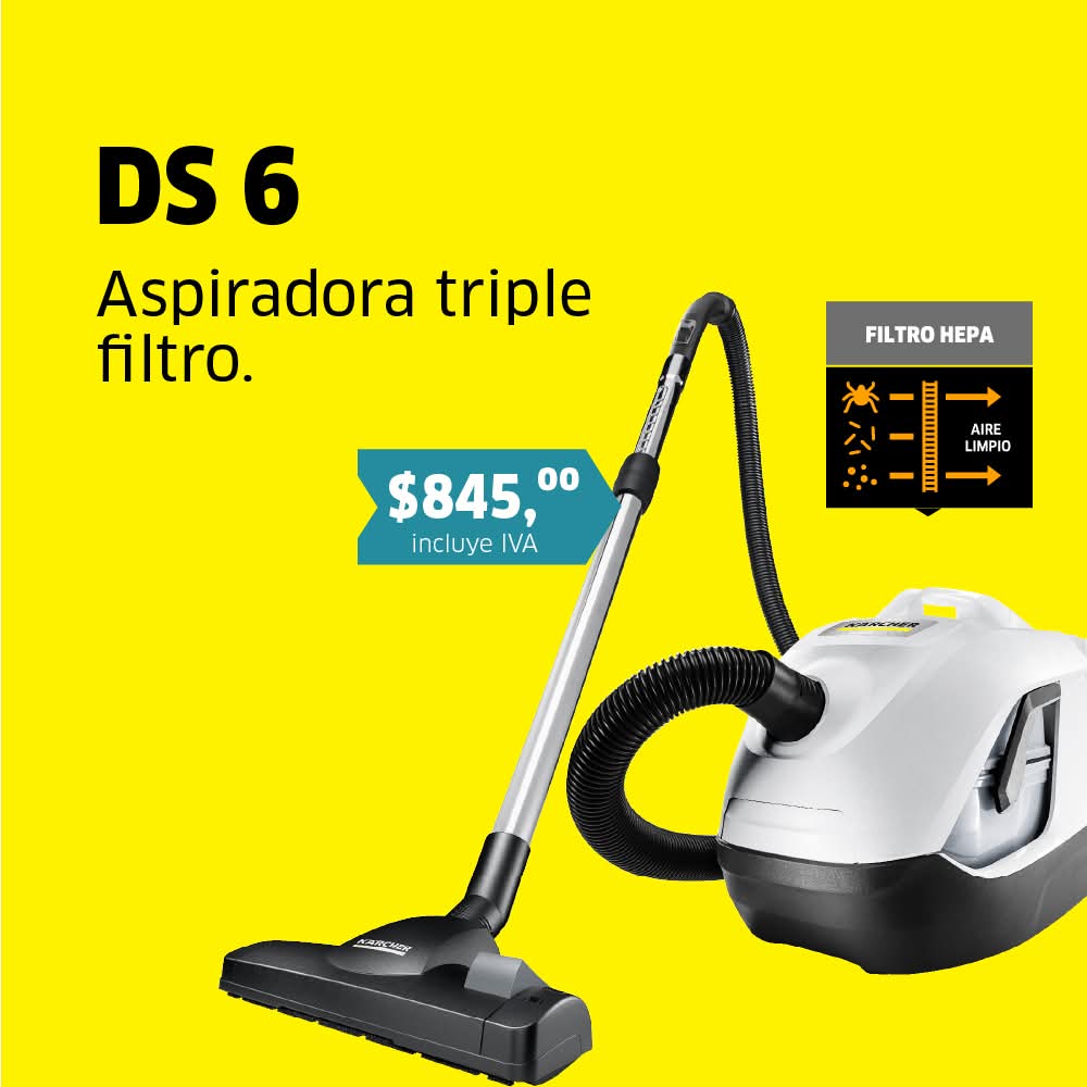 Aspiradora moderna azul y negra en una sala luminosa con plantas y muebles minimalistas.