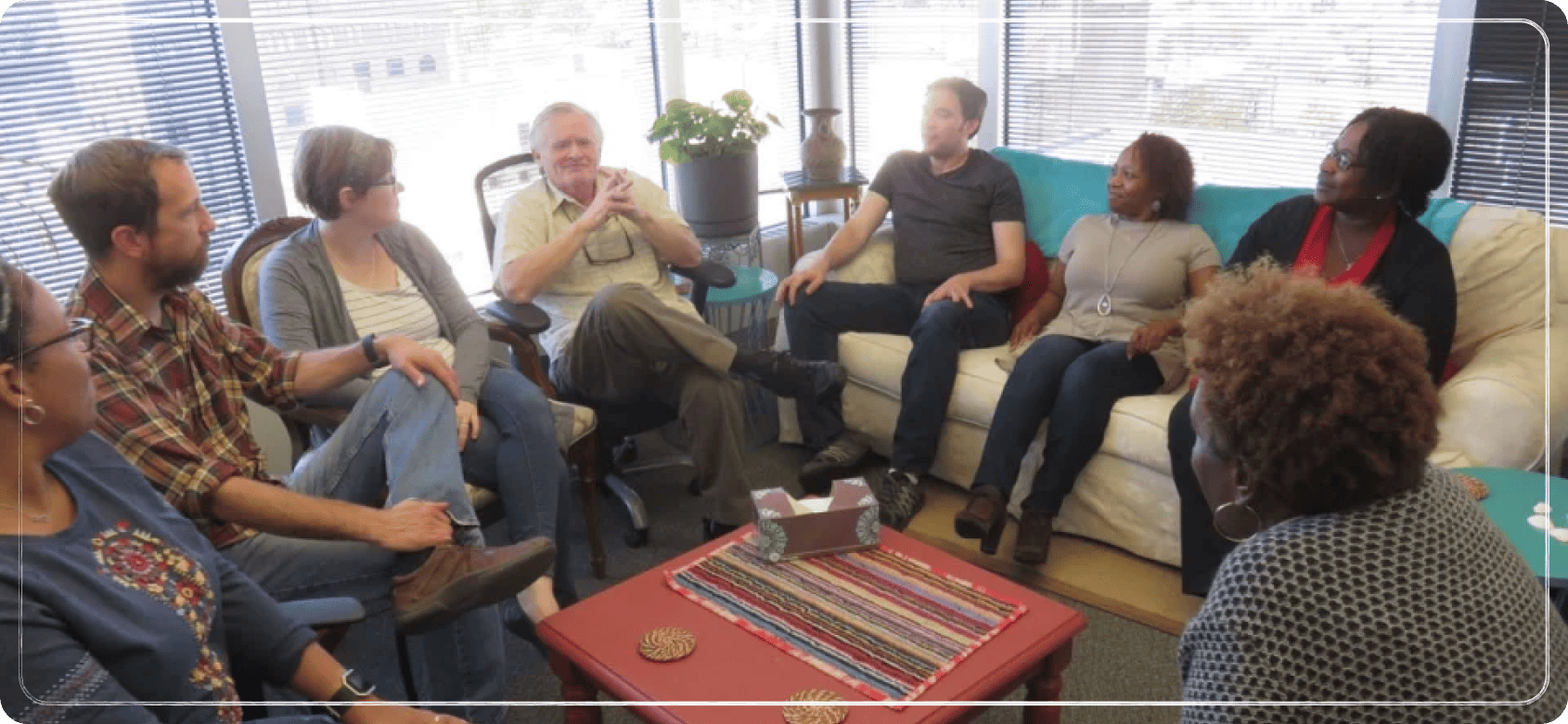 A varied group of people in a group therapy session.