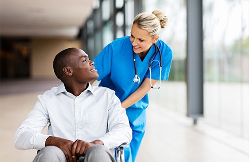 Nurse Talking To Disabled Patient