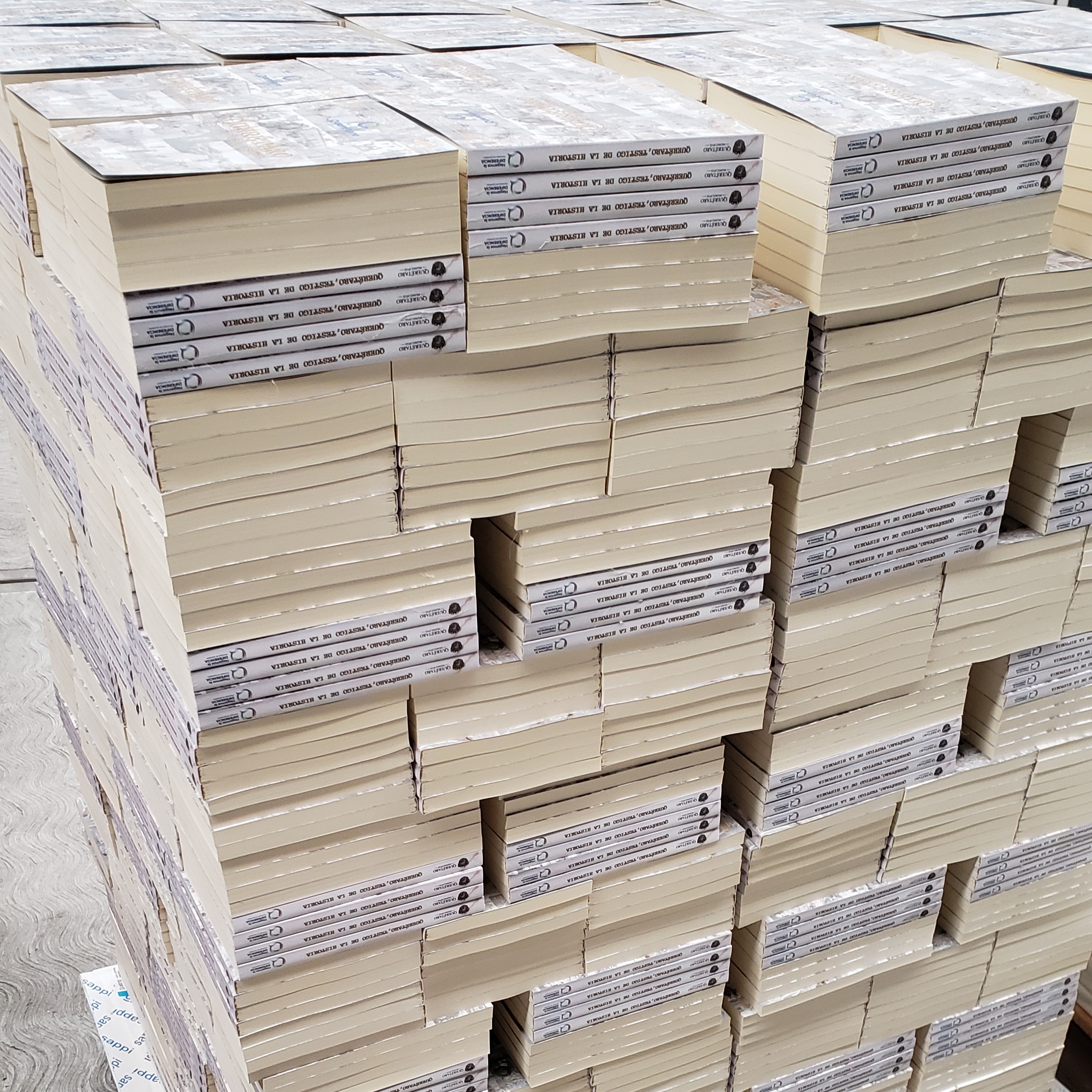Happy child with glasses holding books and an apple on top