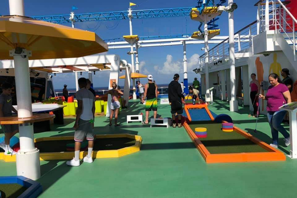Cruise ship deck with a mini-golf course in use.