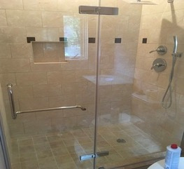 Guest bedroom custom built walk in shower with glass doors.
