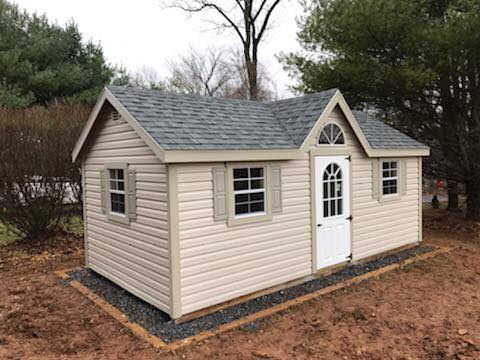 10 x 20 New England Deluxe Cape Cod Dormer in Vinyl                           
                                                              
Featuring sand colored vinyl siding, sand colored trim, and charcoal gray colored 30 year architectural shingles. Gable vents, pressure treated floor joists, 6’ wide Fiberglass doors,1- 3’ 9-lite steel door, vented soffit , (2) larger 24”x27” windows, 1- additional 24”x27” window, half round window in place of standard octagonal window in dormer,  sand colored raised panel shutters.