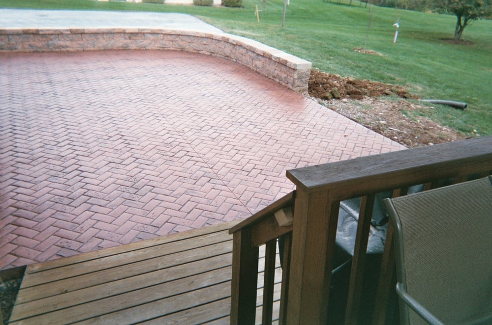 Herringbone brick patio with retaining wall