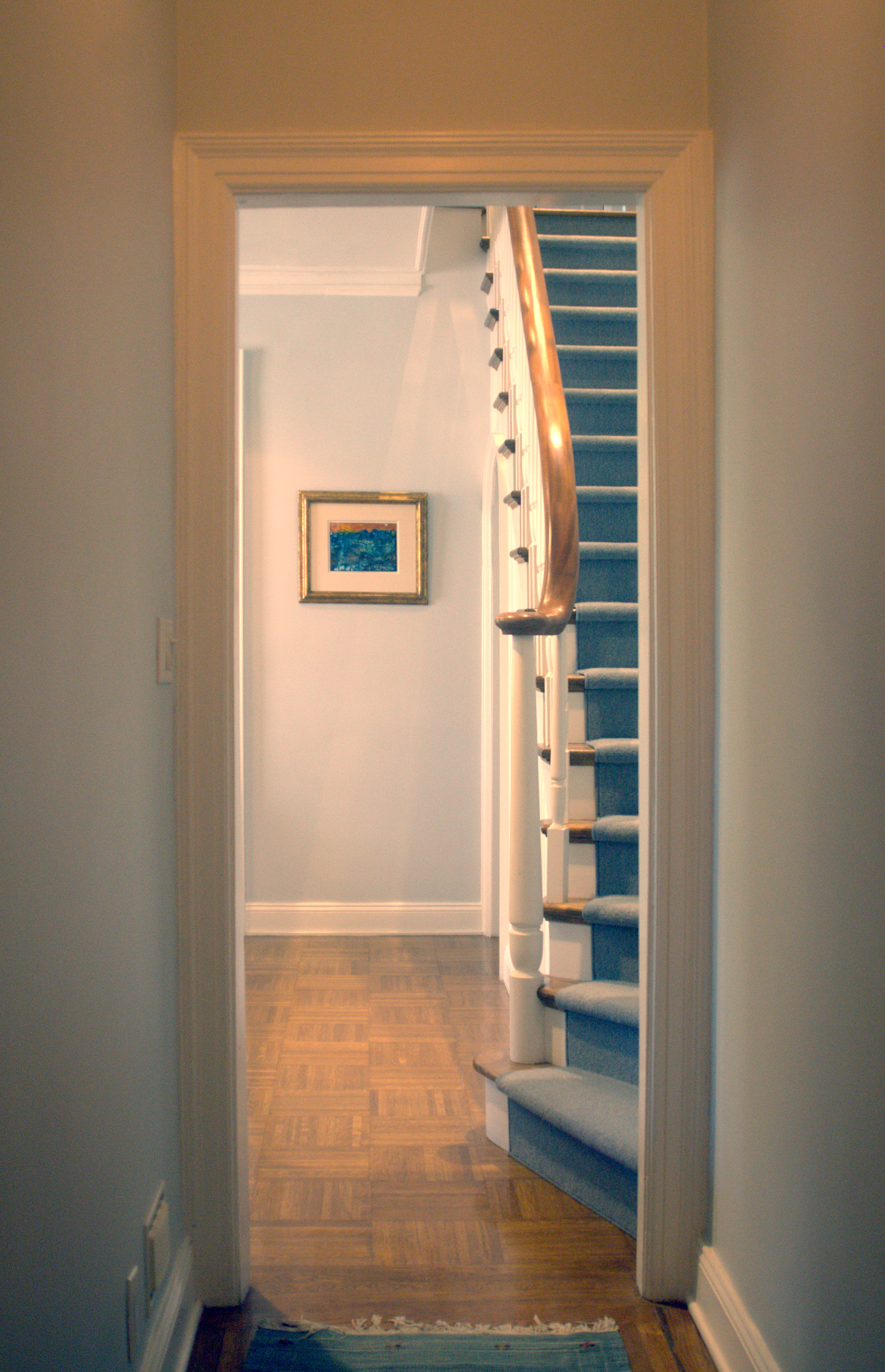 The new stair seen here from the entry vestibule so that the combined apartment feels like a townhouse in the sky.