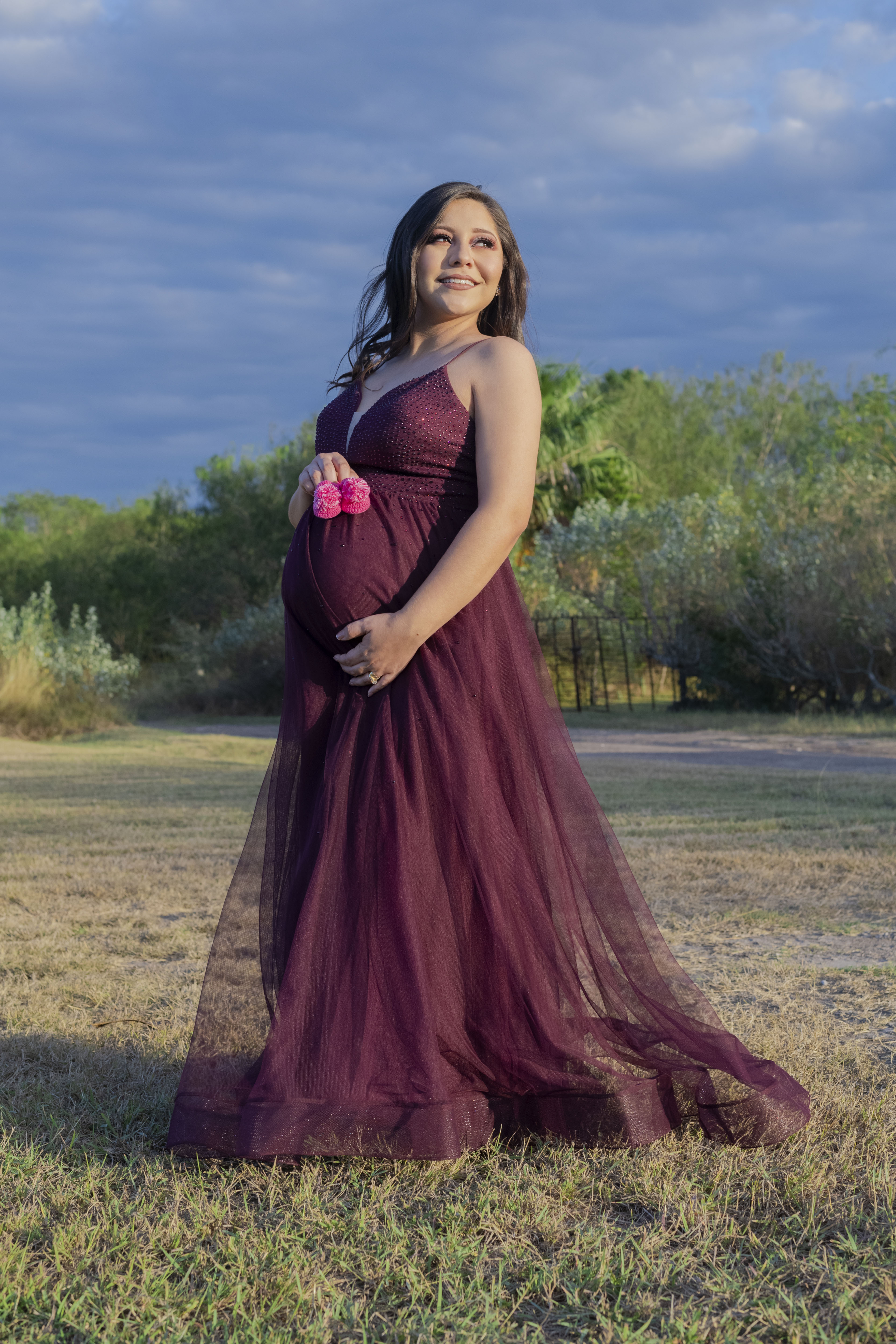 Woman wearing a pink dress and grey boots