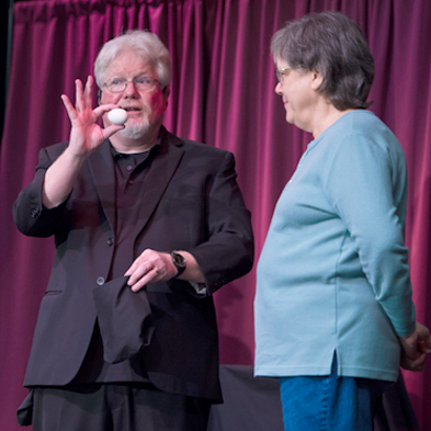 Chuck actively engages audience members close-up, in parlors, and on stages like this one.