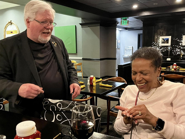 Just having magically produced a small gemstone, Chuck gives it to this spectator who reacts in amazement.