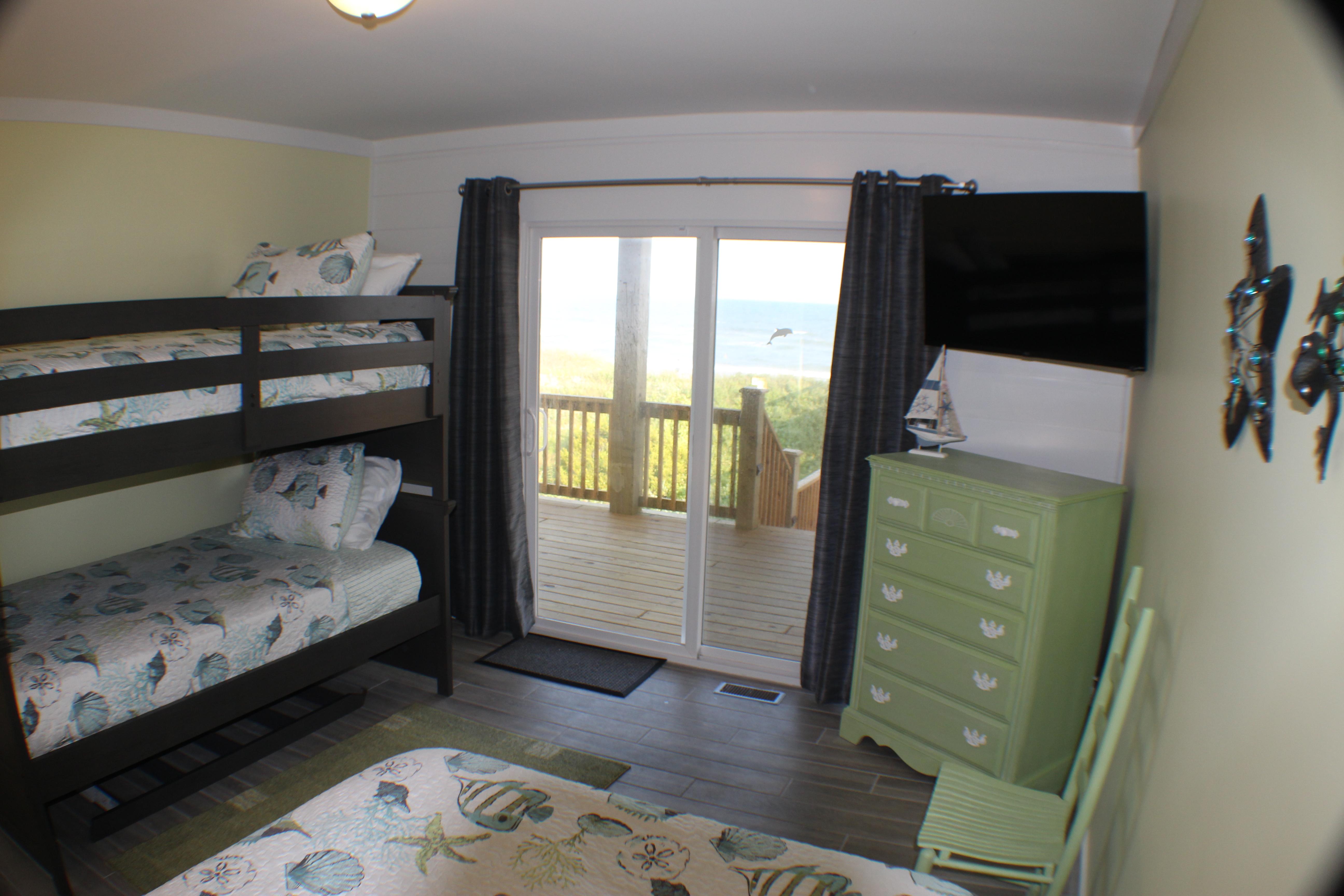 Ocean View of the Yellow kids bedroom with double and twin bunk beds.  TV in the corner.
