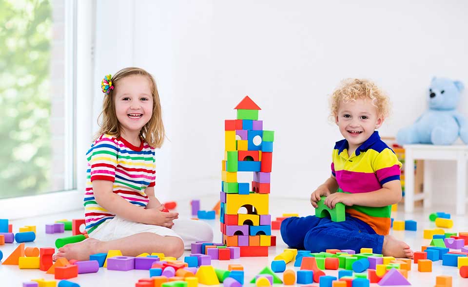 Kids Playing With Colorful Toy Blocks