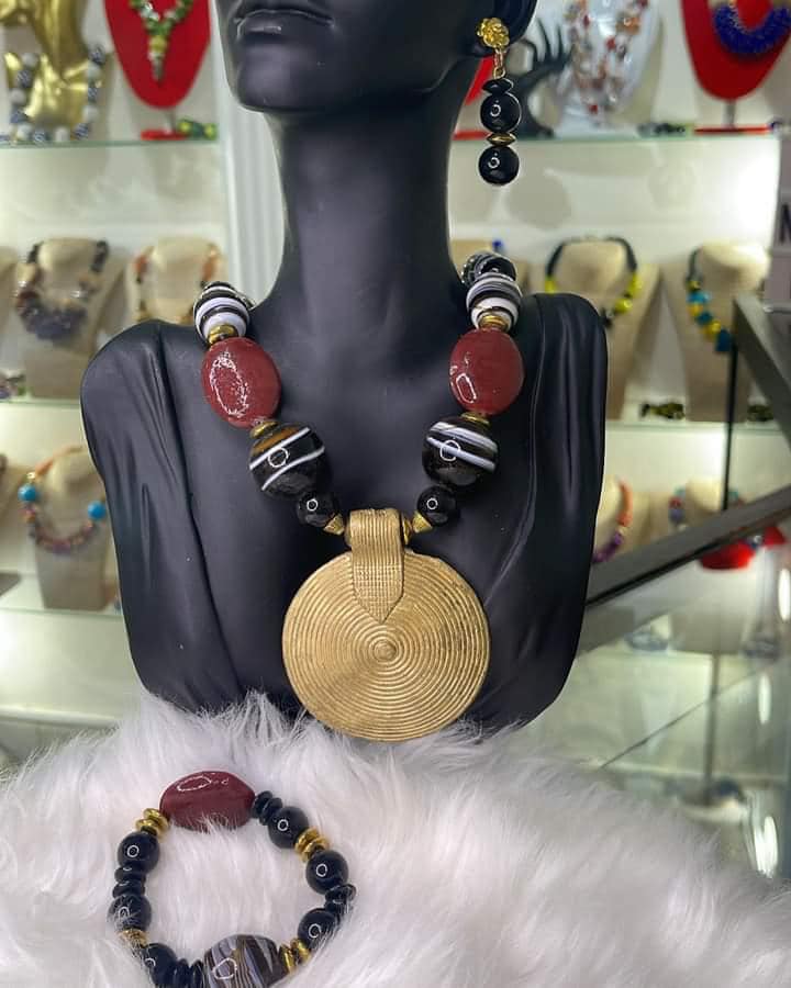 Yellow medalion with a black and white necklace