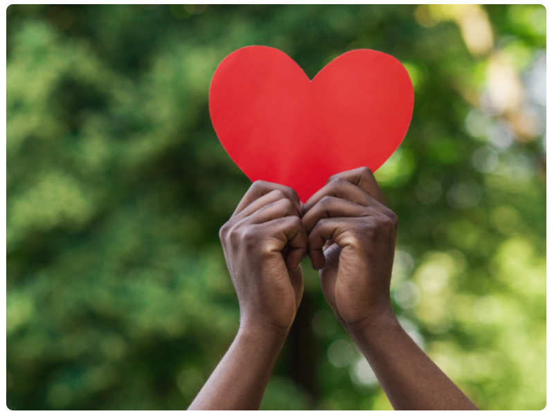 Holding red paper heart 