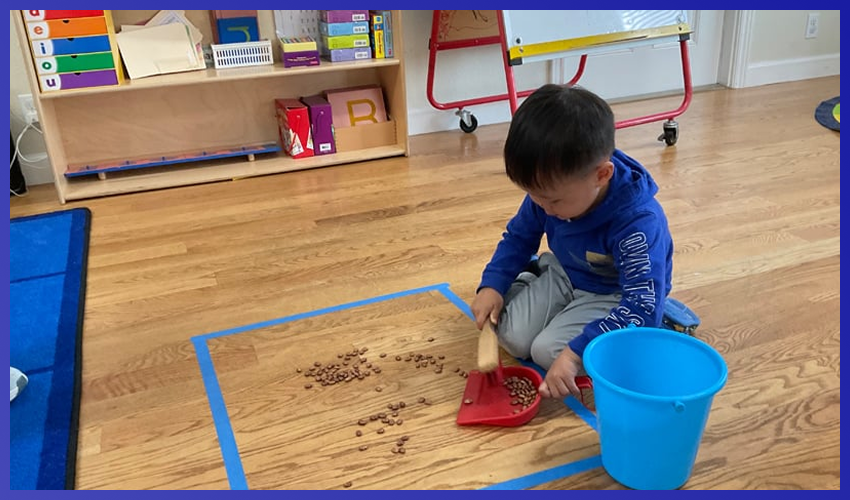A little boy playing with beans