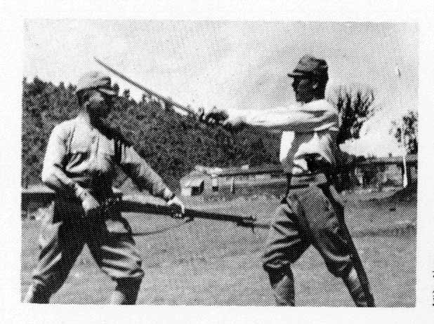 At Camp Jinmu on the North China-Soviet border 1944. Conducting a special performance of sword versus bayonet forms during a military festival. 
Bayonet, Sergeant Major Yoshii; Sword, Sergeant Nakamura Taizaburo. (Photo courtesy Nakamura Taizaburo) 