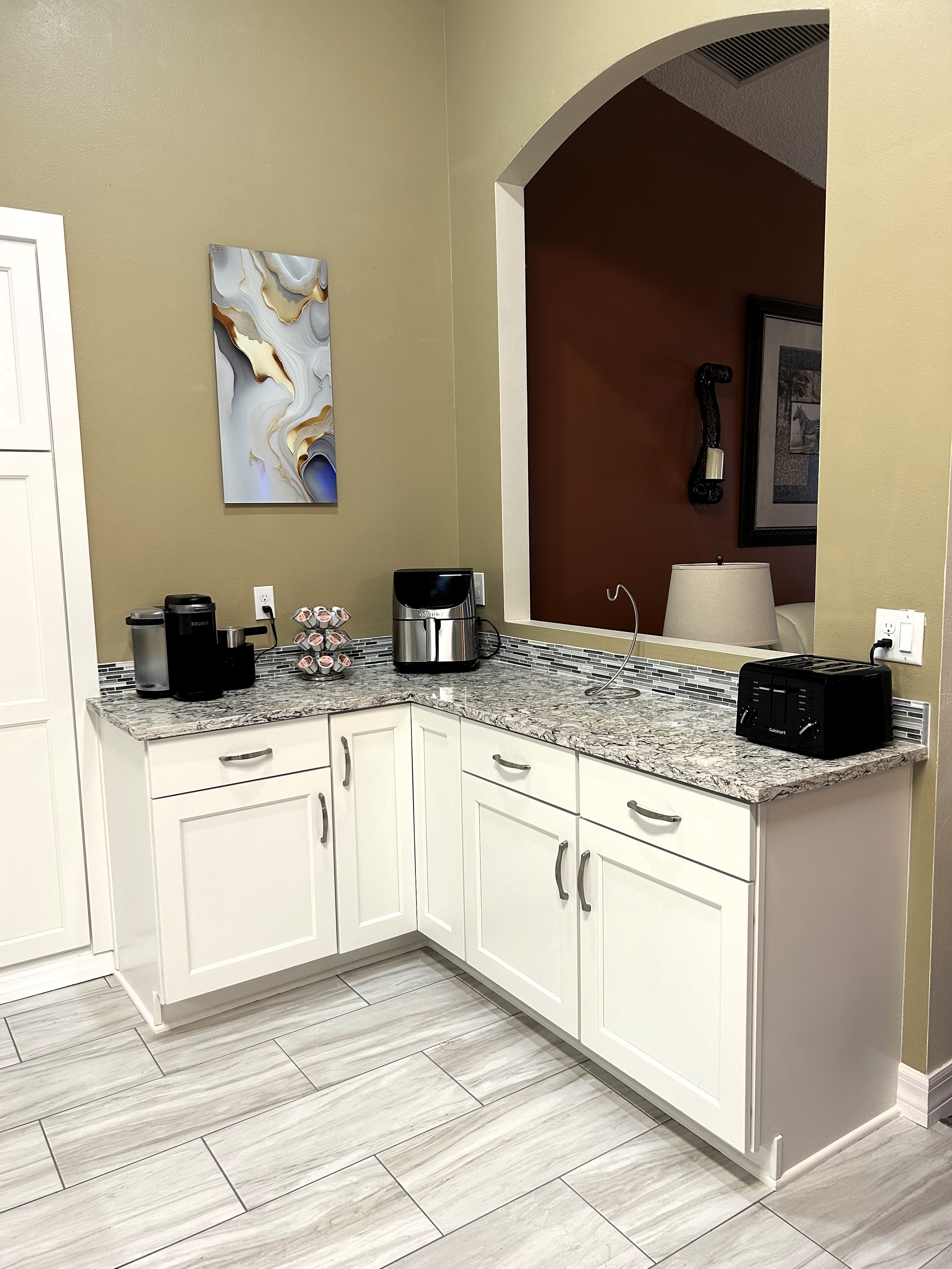 Picture perfect breakfast area featuring gorgeous Cambria quartz with complimenting backsplash.