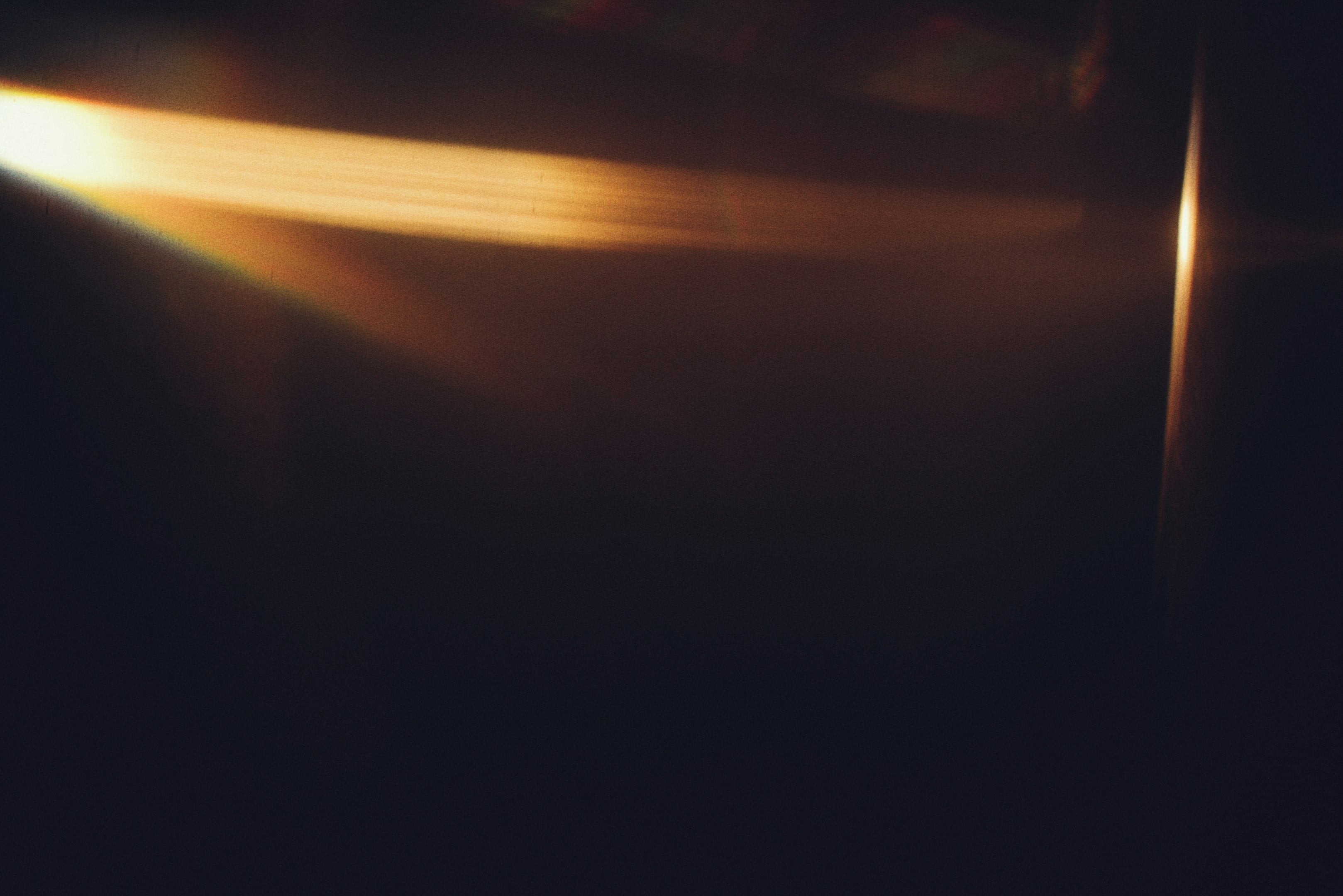 Golden light flares on a dark background