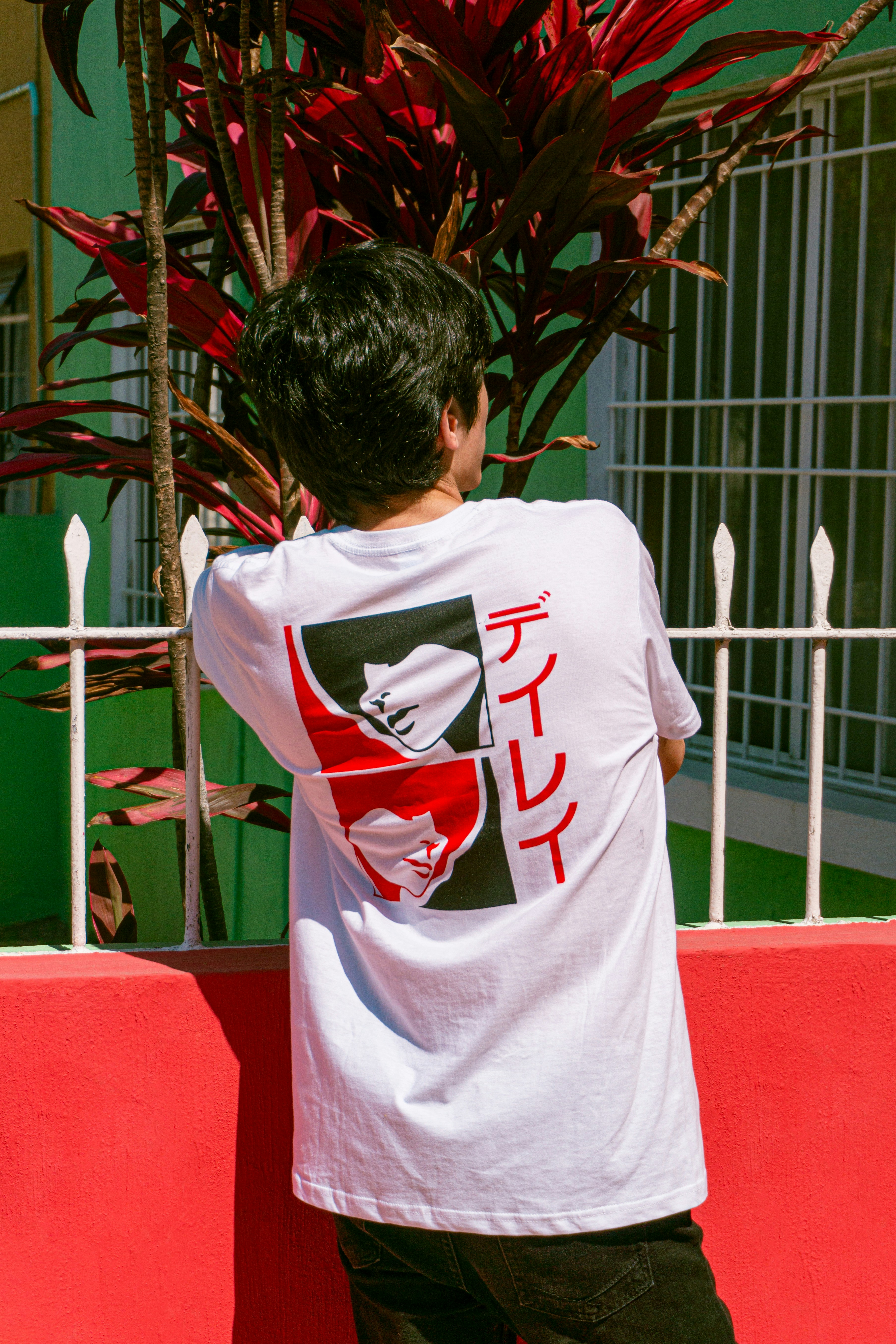 Conjunto deportivo azul oscuro compuesto por una camiseta y pantalones cortos en una mesa de diseño moderno, con equipo tecnológico de fondo.