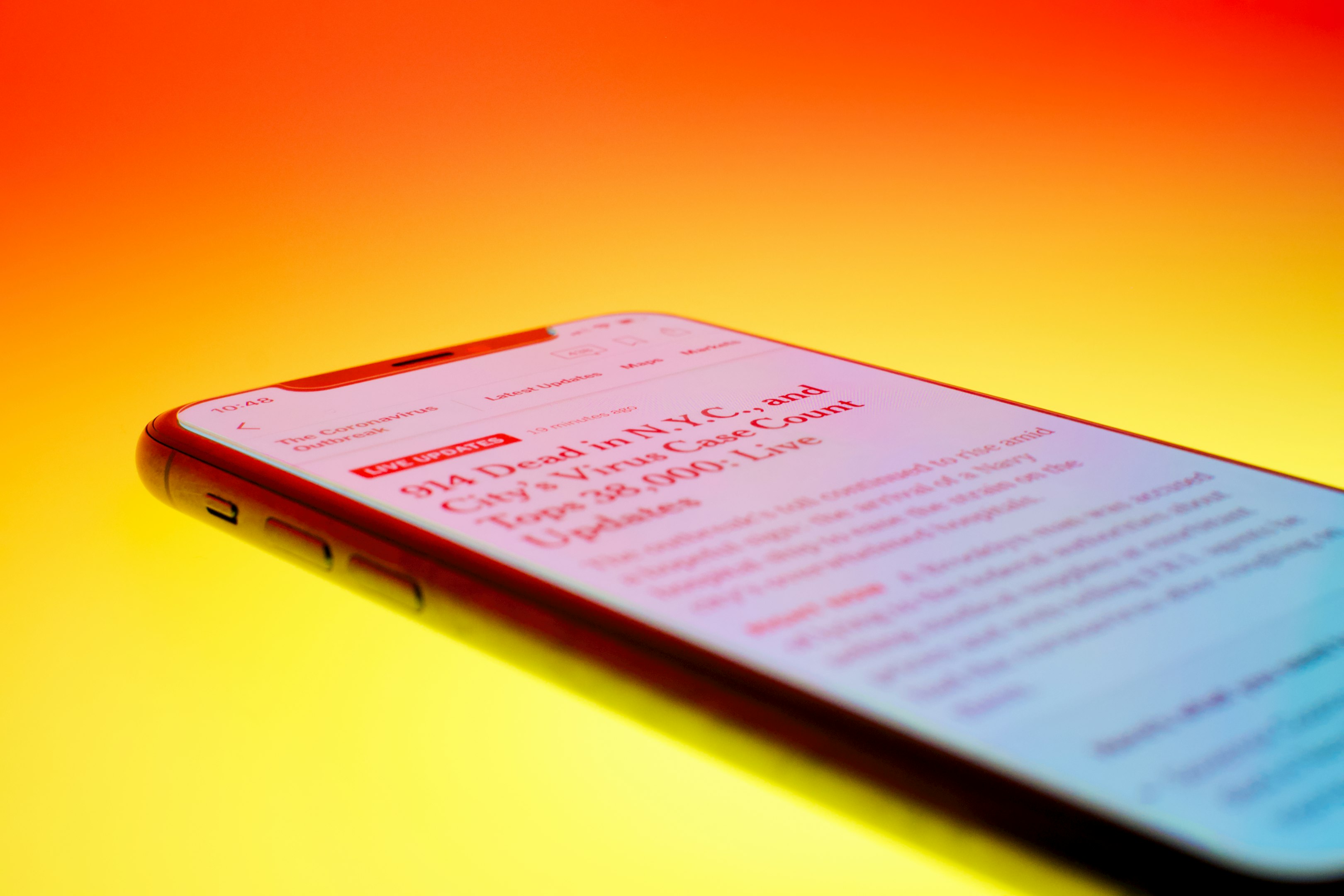black android smartphone on orange surface
