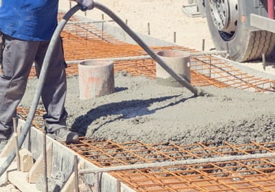 Construction Worker Leveling Concrete Pavement Outdoors