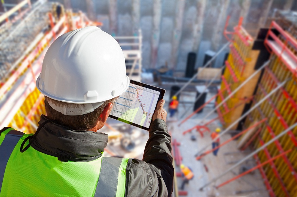 Construction worker using tablet on worksite