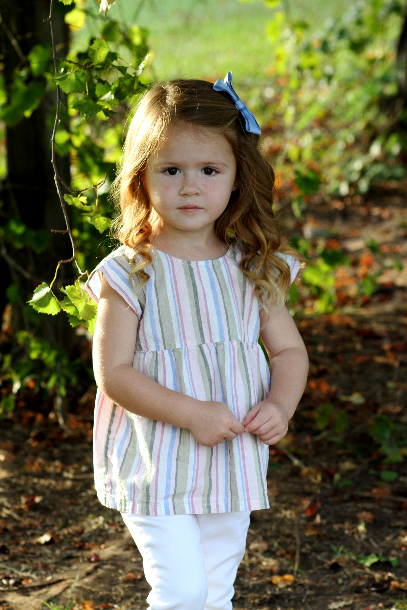 Young girl standing in a garden