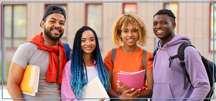 African American teenage students smiling and holding their books