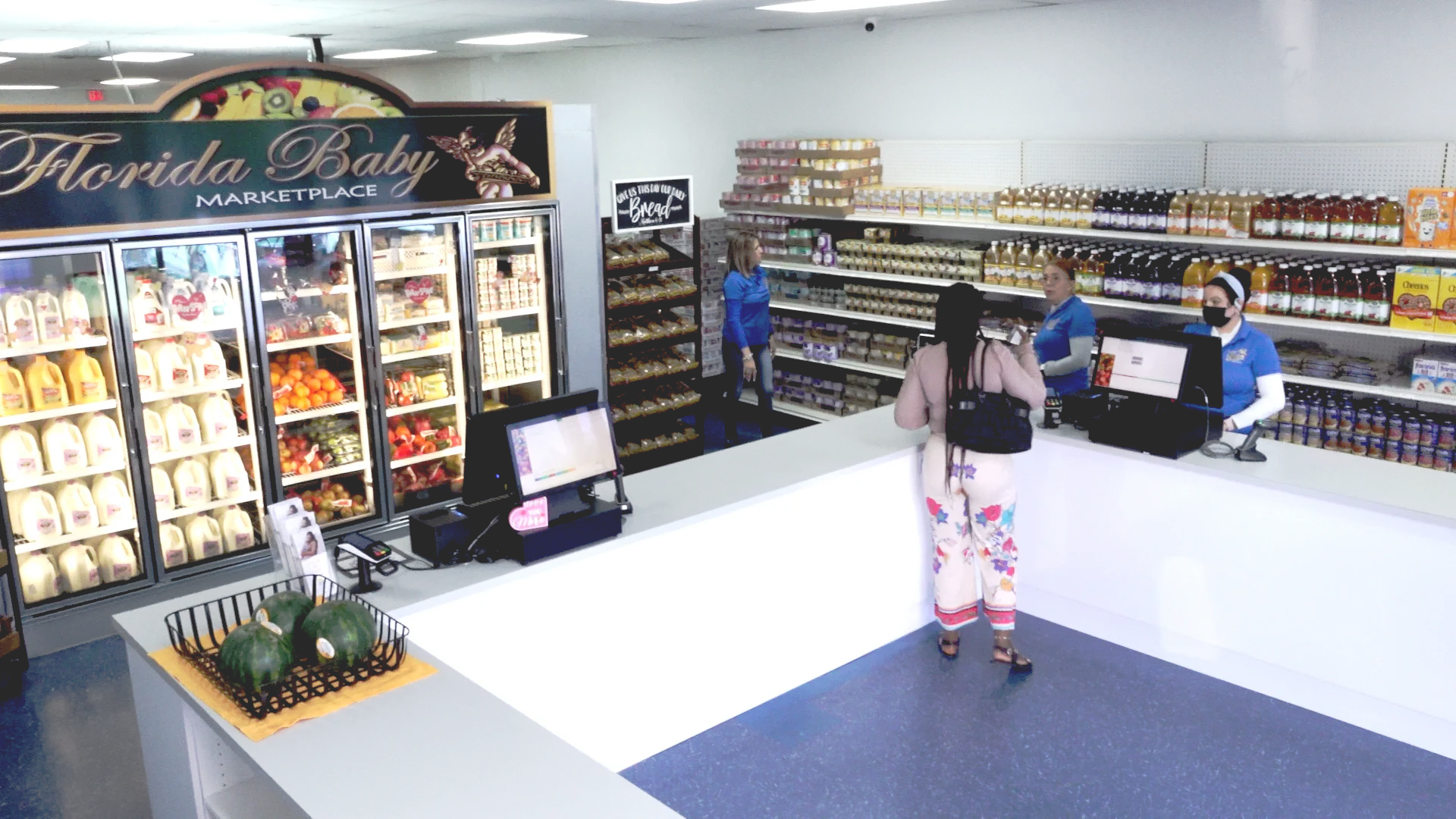 Interior of a WIC-only store featuring shelves stocked with various grocery items and a refrigerated section.