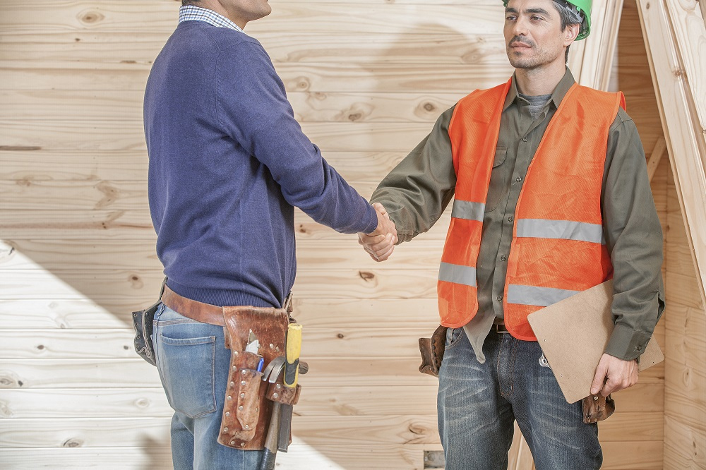 Contractor and worker shaking hands