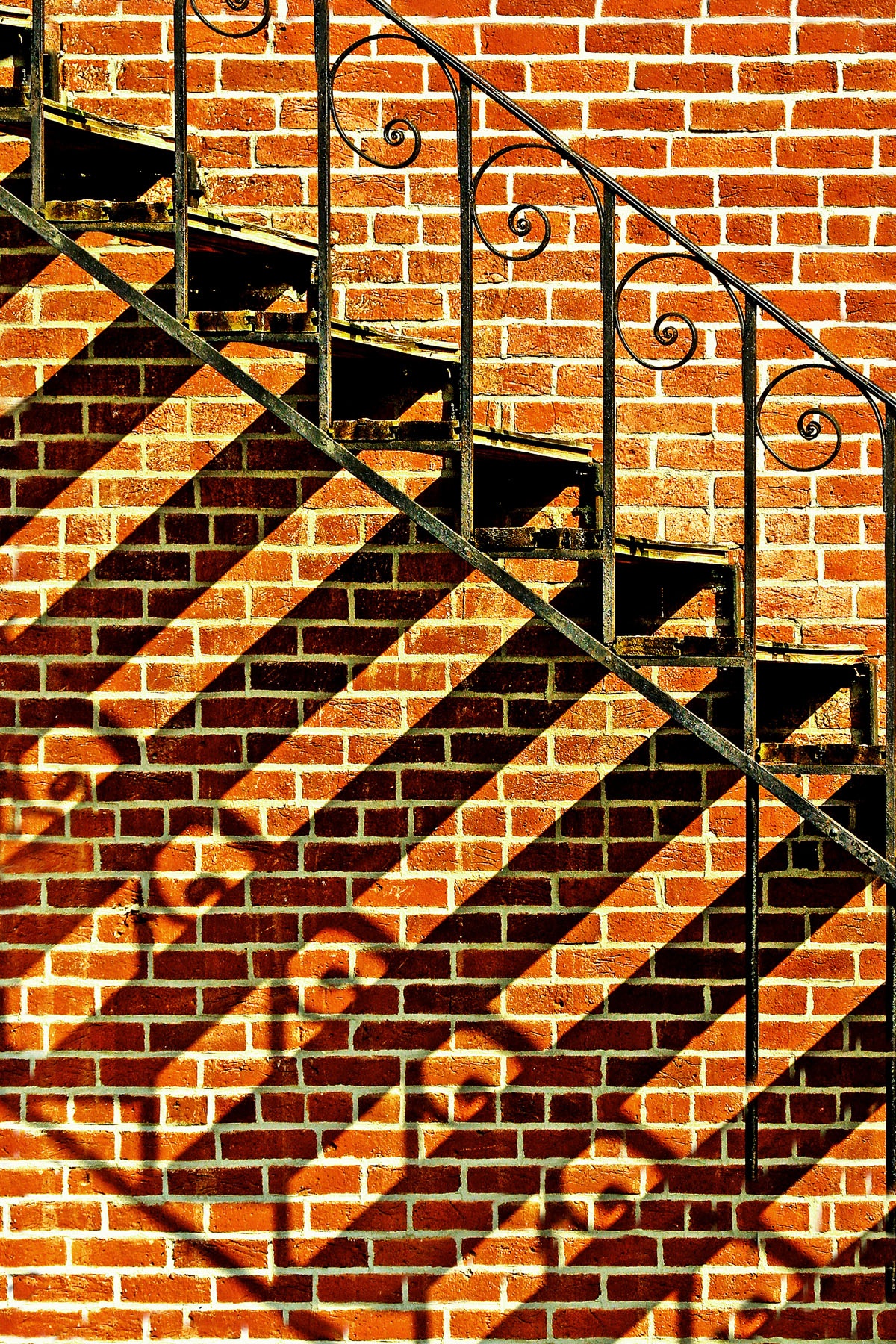 SHADOWS ON THE WALL - Sometimes you get a photo just because you are at the right place at the right time. I was just walking around a small town looking for a photograph, and this was there. It’s one of my favorites.