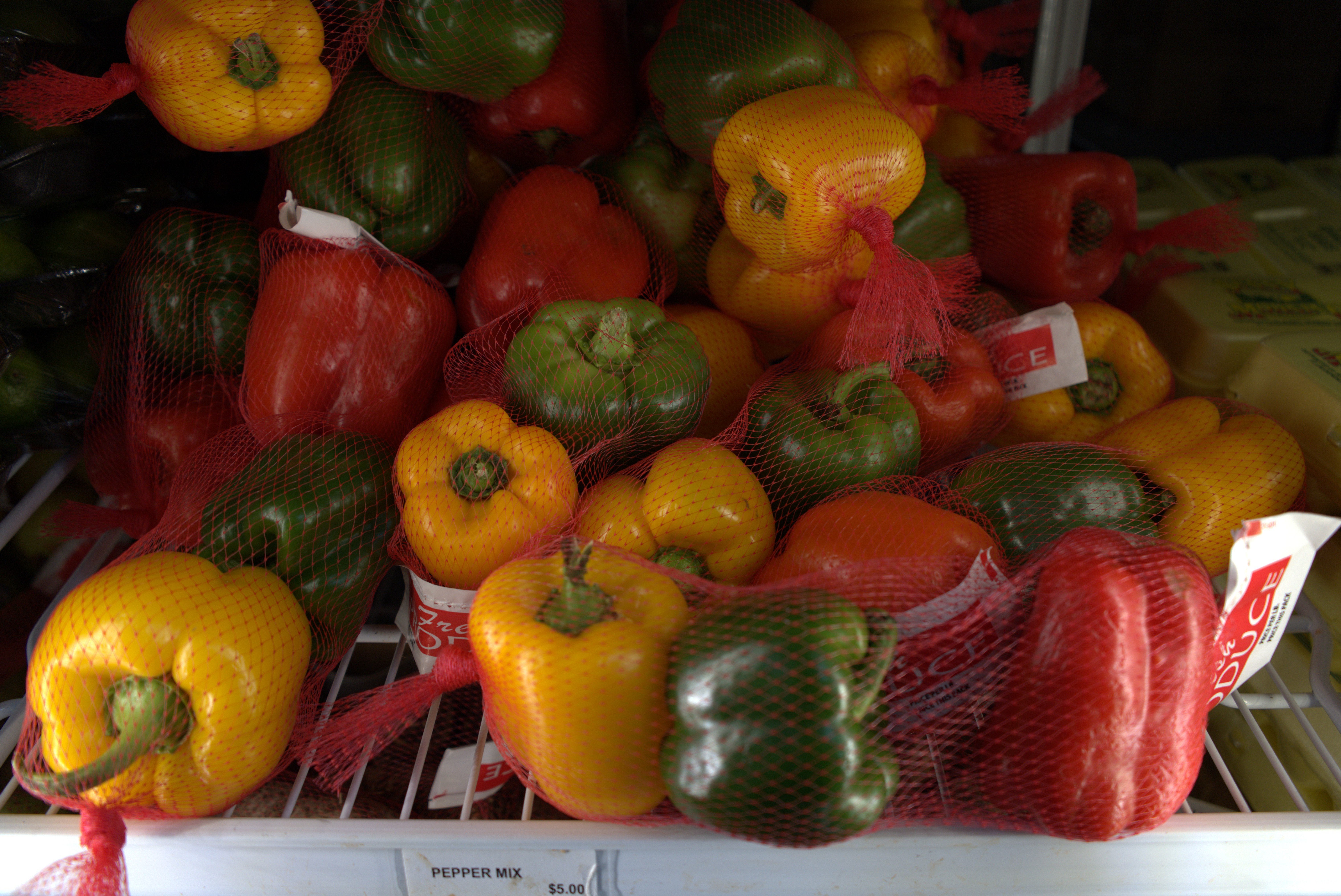 Interior of a well-lit supermarket aisle with neatly arranged food products on shelves.