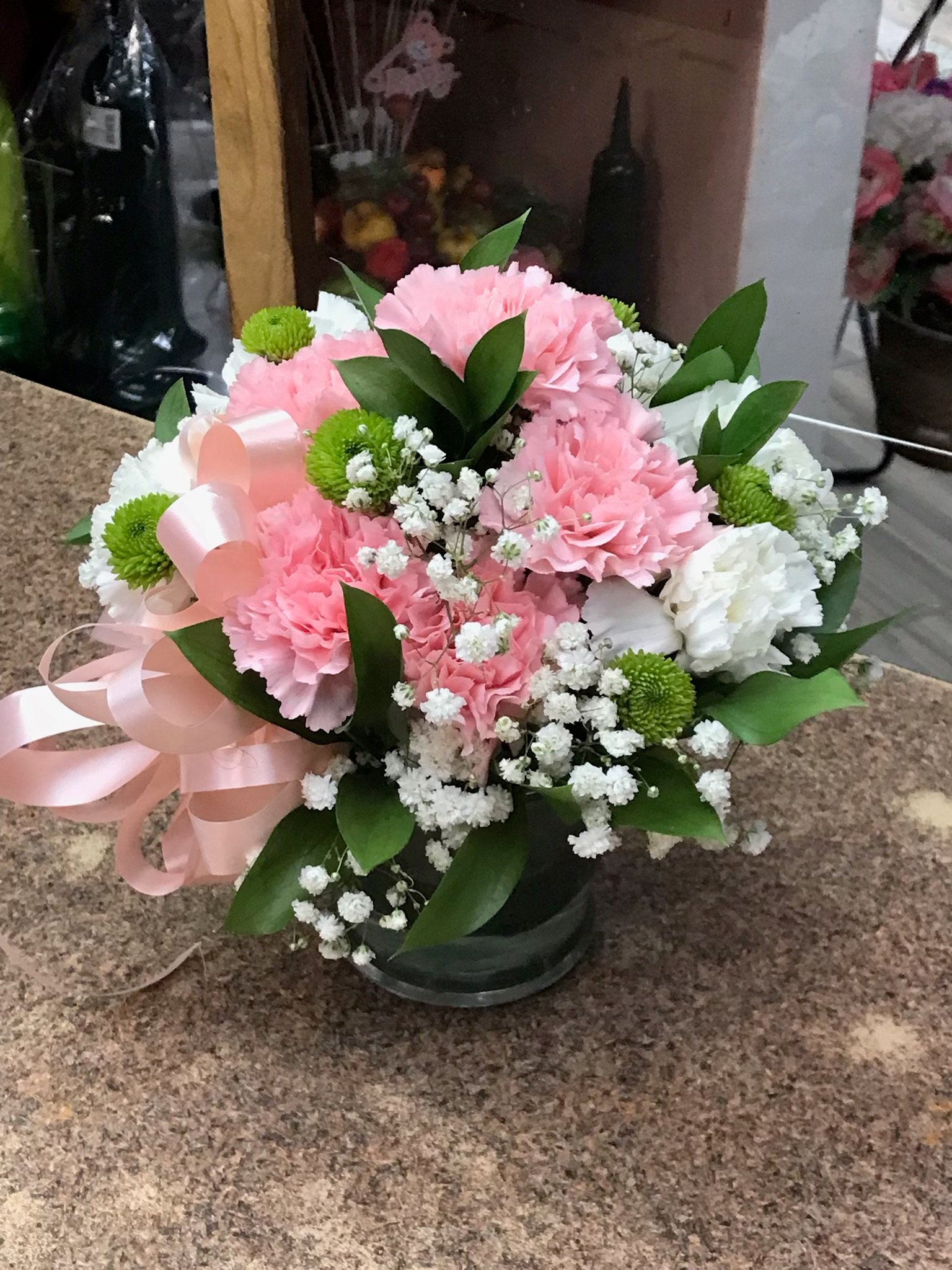 white flowers in pink vase