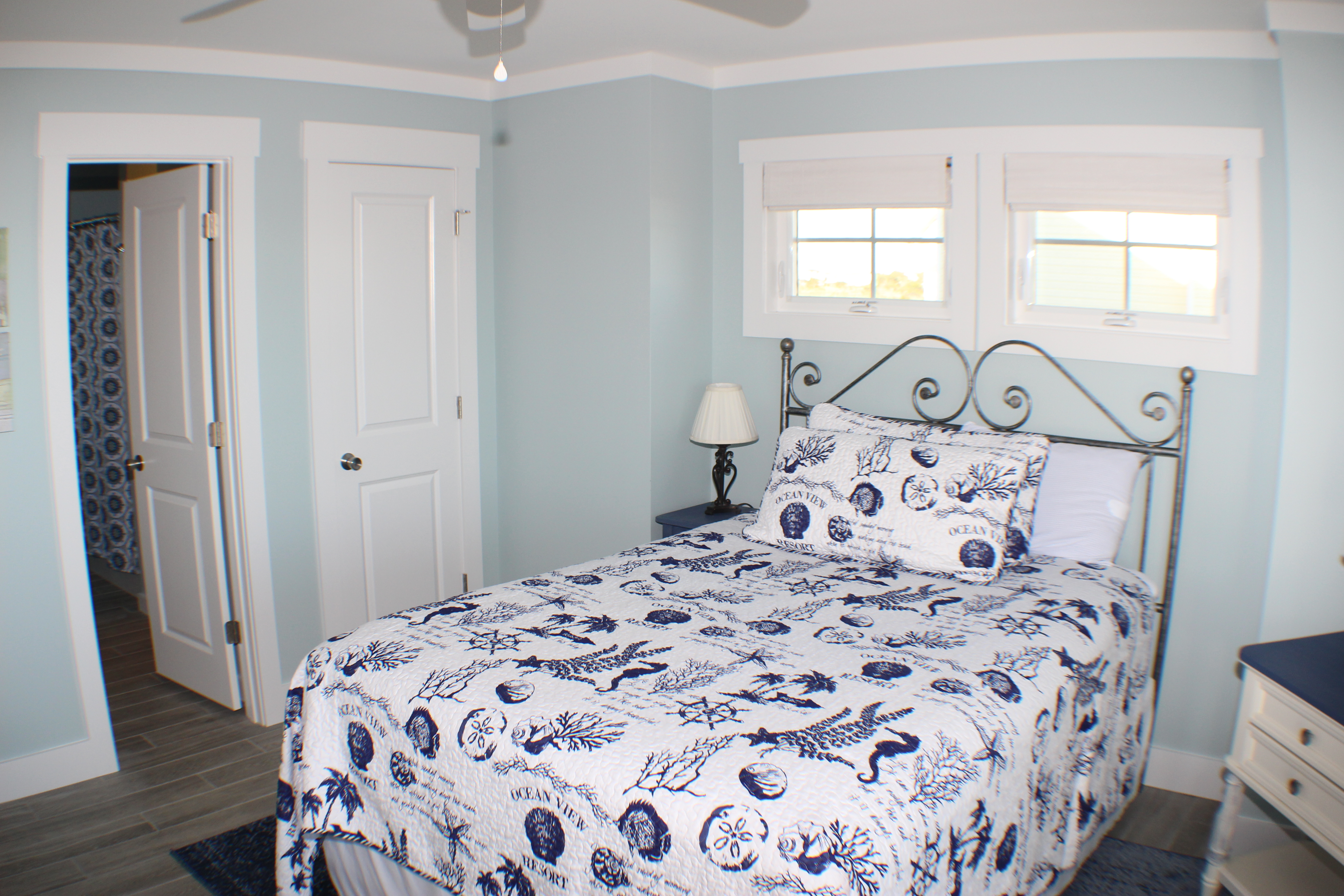 Blue bedroom with bathroom entrance and closet