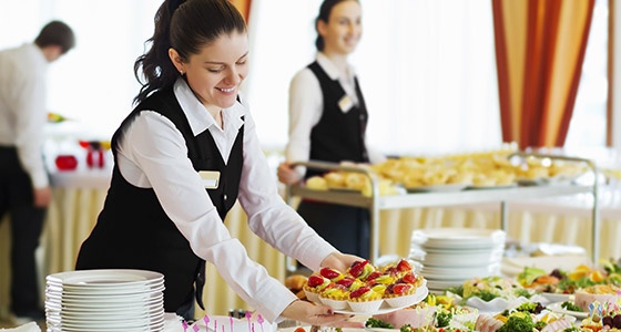 Waitress Serving Table with Food