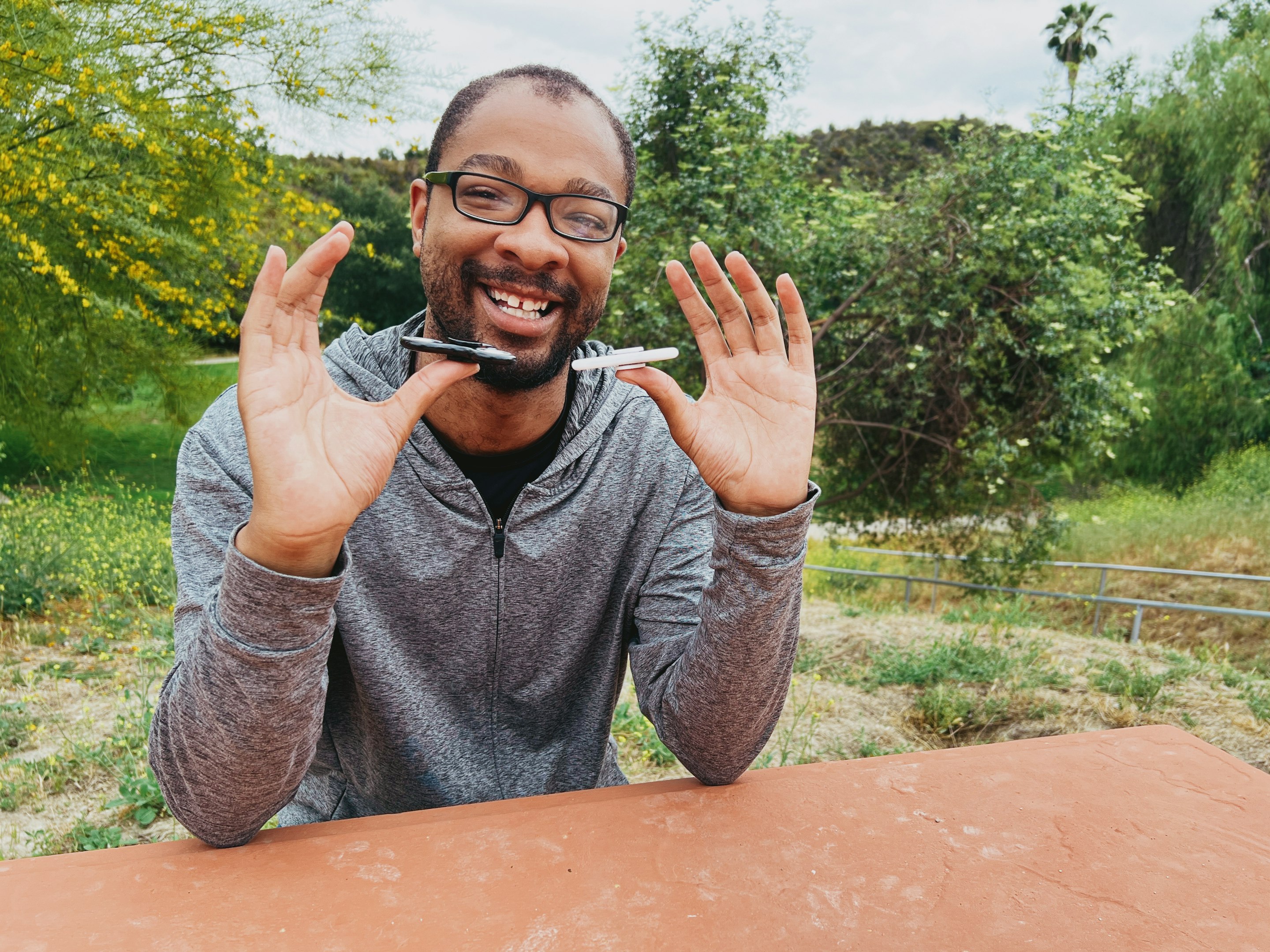 Happy child with glasses holding books and an apple on top
