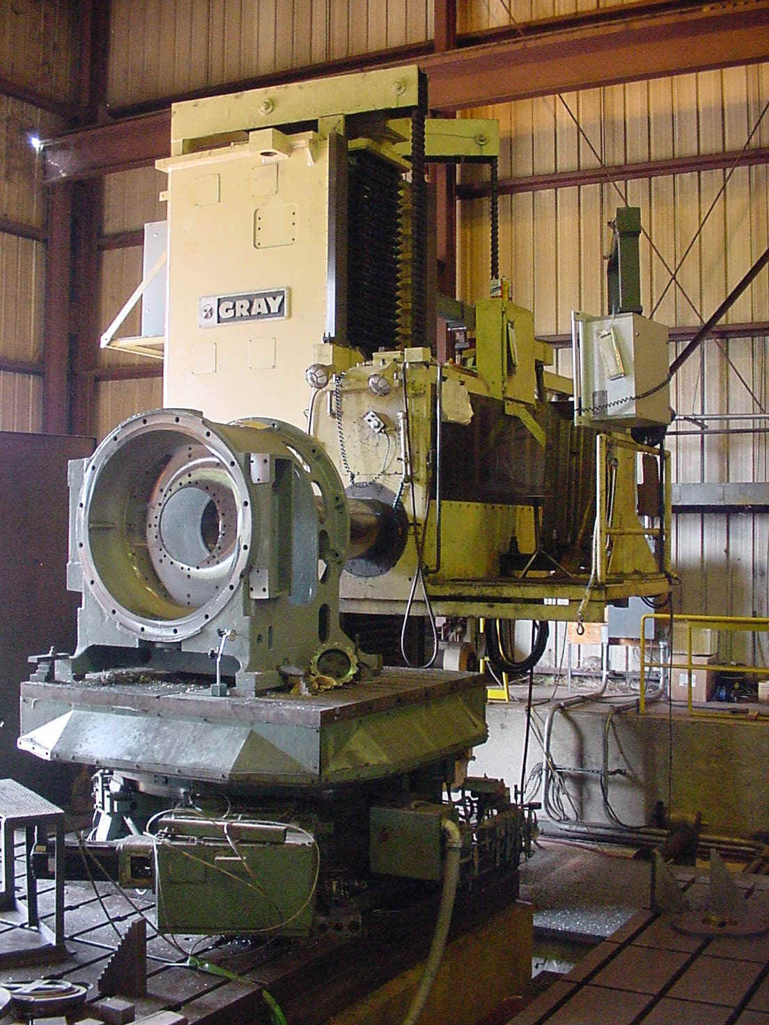 Close-up of a CNC machine cutting metal with sparks flying, showcasing precision machining in an industrial workshop.