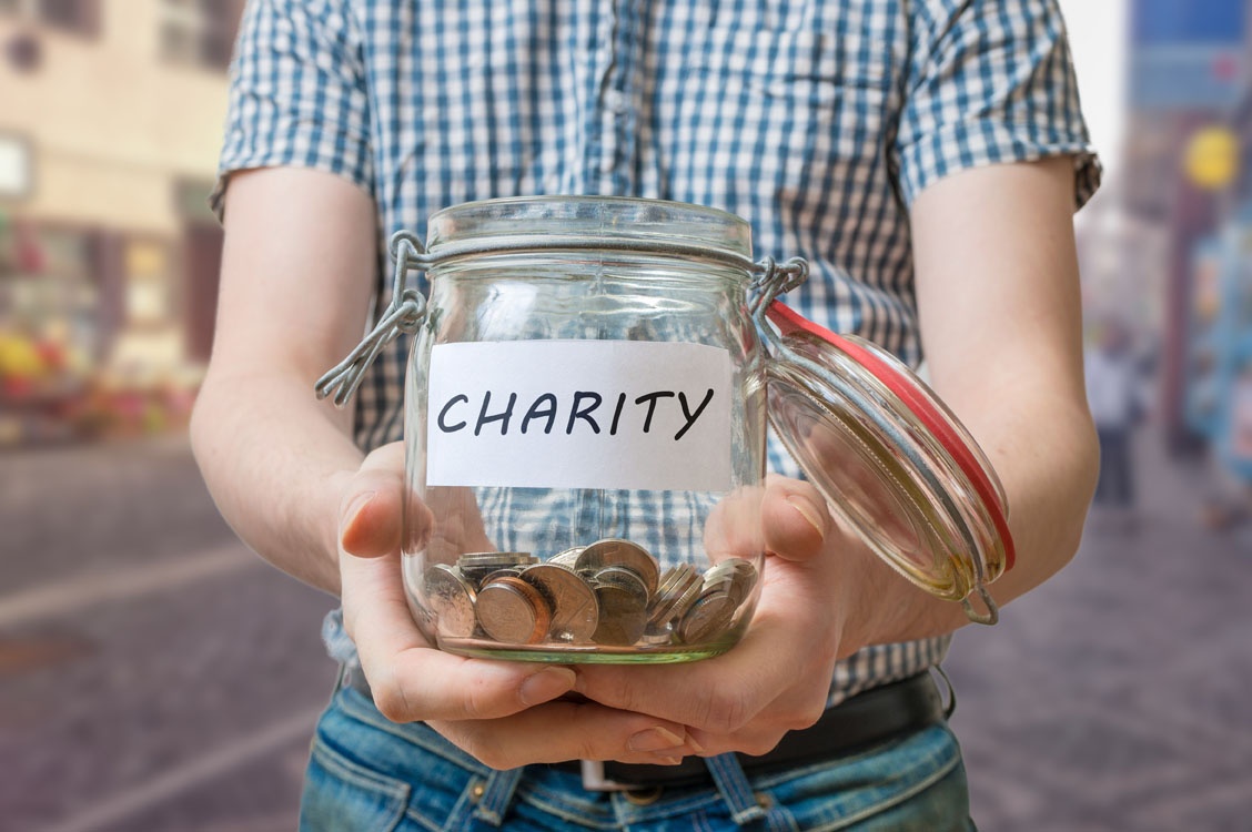 Man Standing On Street Is Collecting Money For Charity
