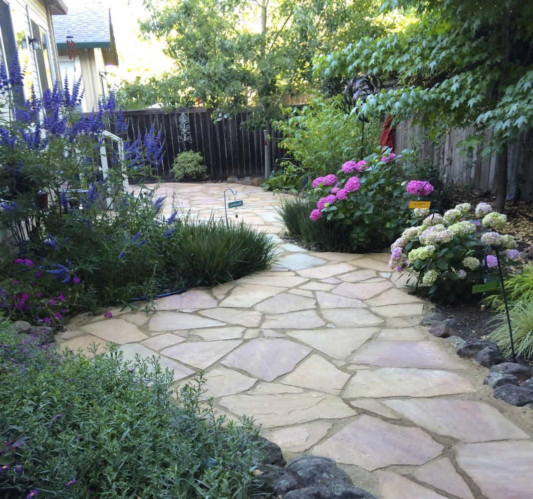 AFTER - flagstone patio to resolve trip hazards, create more seating areas and add color 