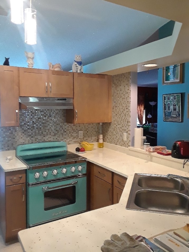 Gorgeous kitchen featuring fun retro appliances in Turquoise and Sunny Pearl Quartz countertops with 4" backsplash.