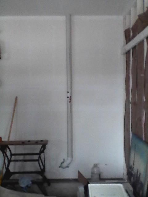 System piped through attached garage.  Fan is concealed in garage attic