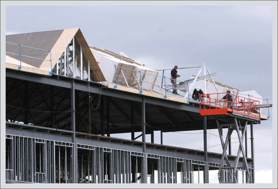 Men working on roof installation Men working on roof installation