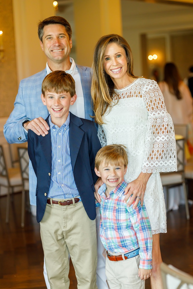 Family photo, mother, father and 2 sons all standing