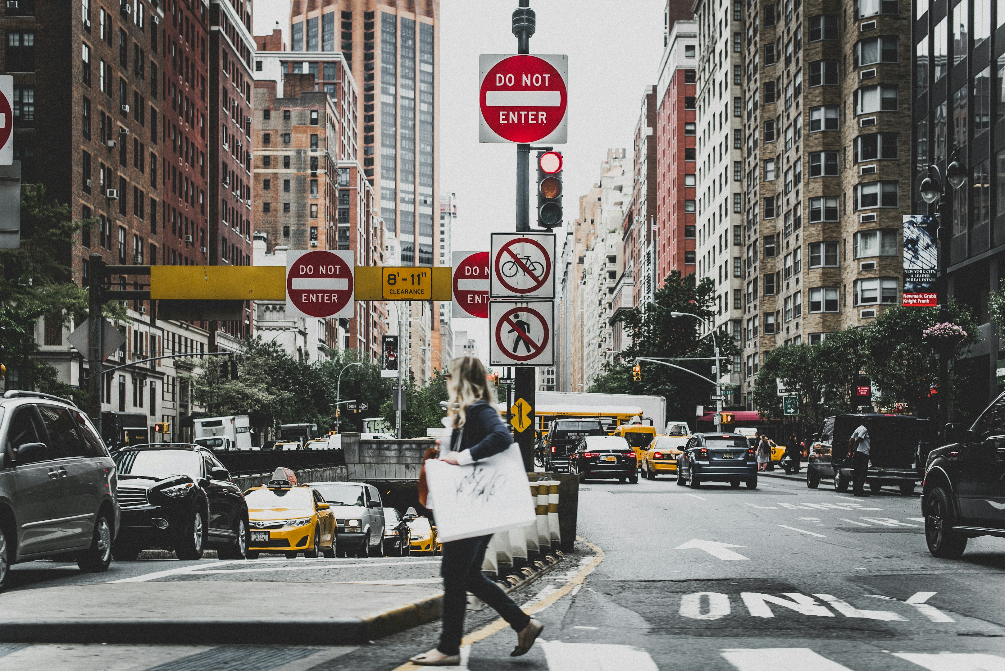woman walking on road near cars
