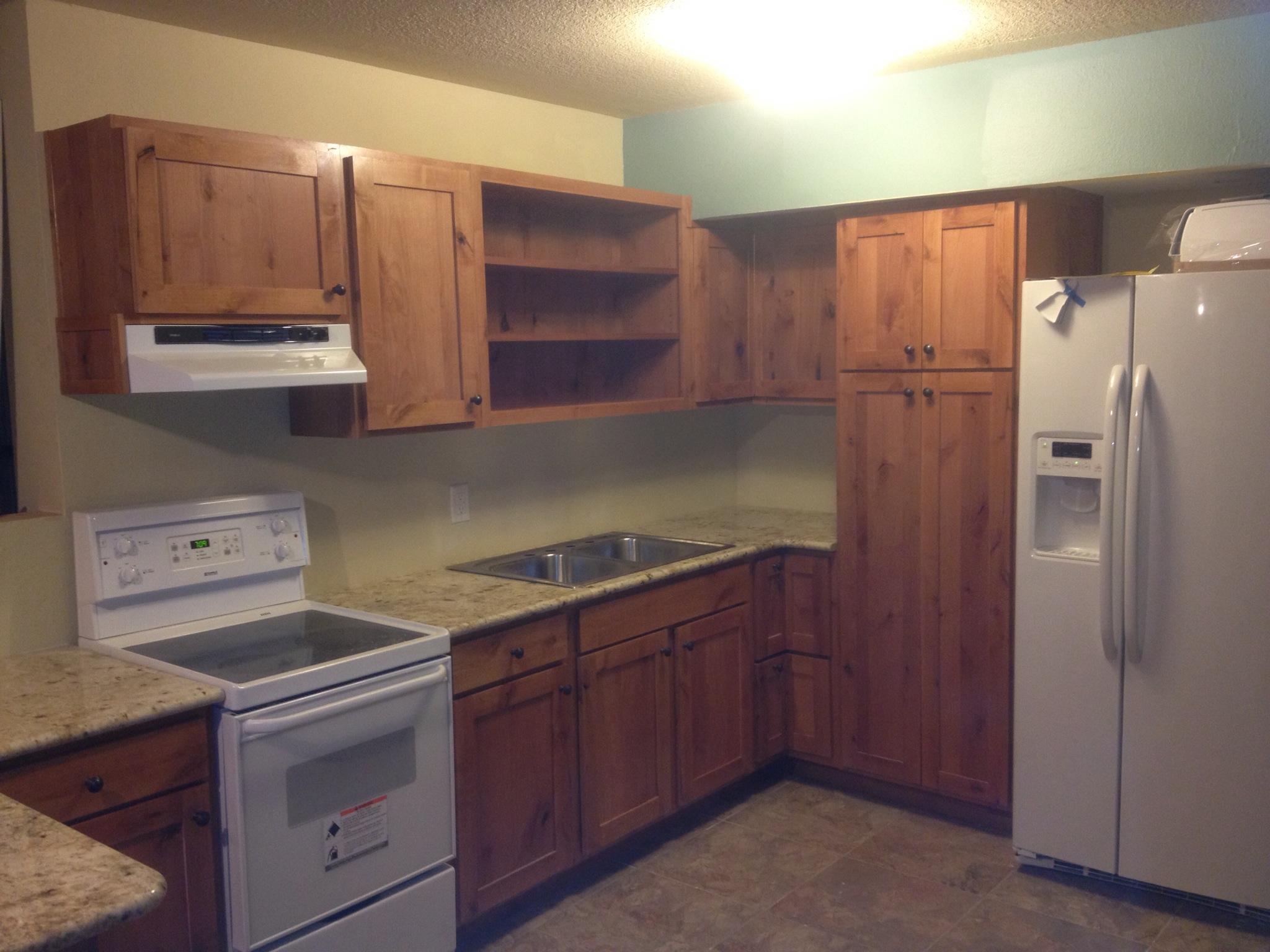 Cabinets feature Shaker Style Knotty
 Alder doors open shelving and a pantry 
with full slide out shelving.