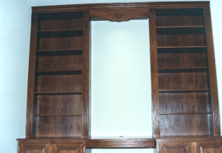 Office computer desk features a walnut finish
 on oak, adjustable shelves, fluted pillisters, rosette
 capitals, crown molding, valance with carved recessed
 applique, file cabinets, slide-out drawers, pen and pencil
 drawer, slide-out shelves, and raised paneled doors with
 recessed carved appliques.