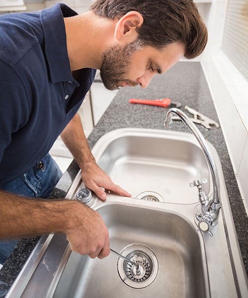 Plumber Fxing Sink With Screwdriver